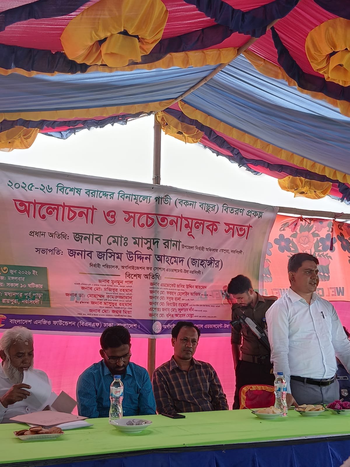 Awareness meeting; speaker at banner.